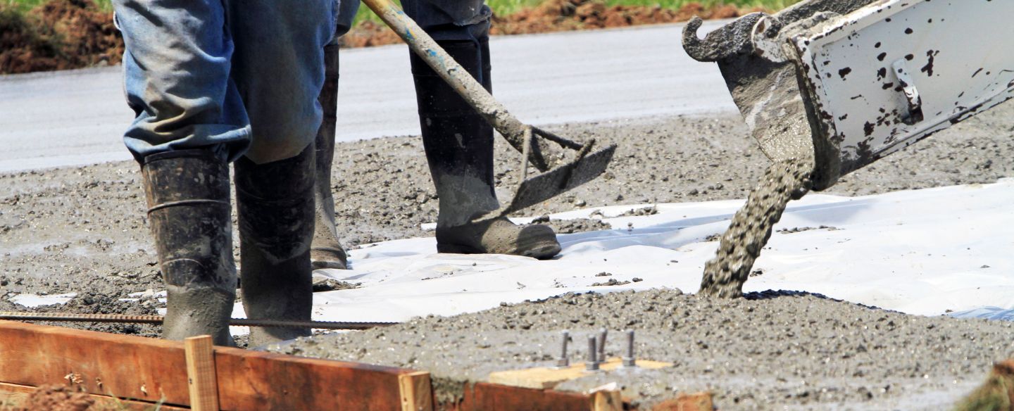 concrete flowing from the shute while workers move it around the form texarkana ar