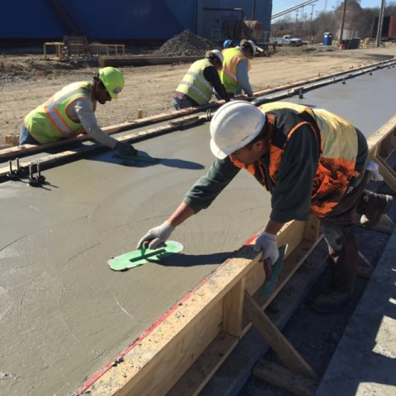 workers finishing concrete work using trowel texarkana ar